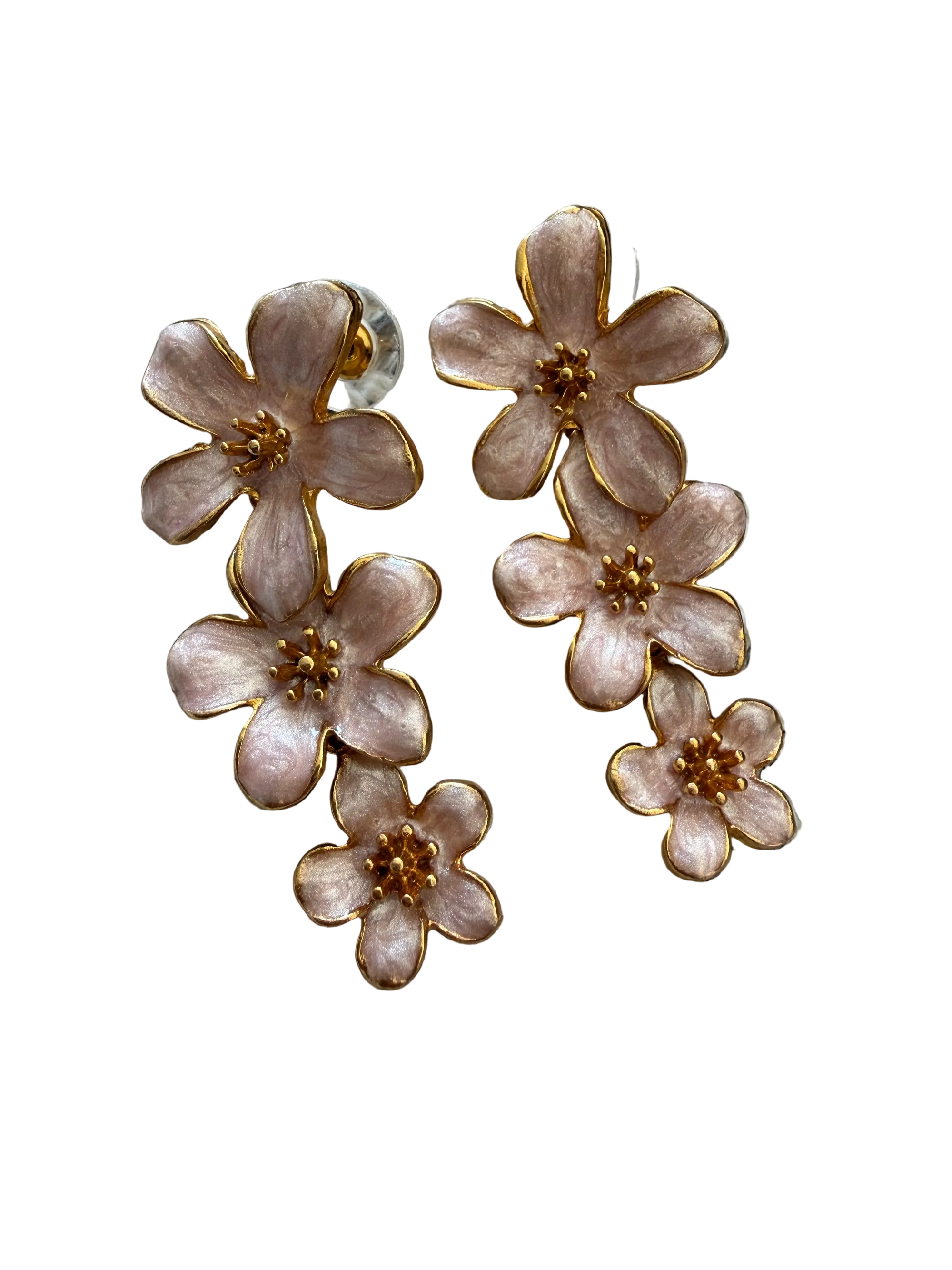 Floral earrings with gold accents on a textured fabric background