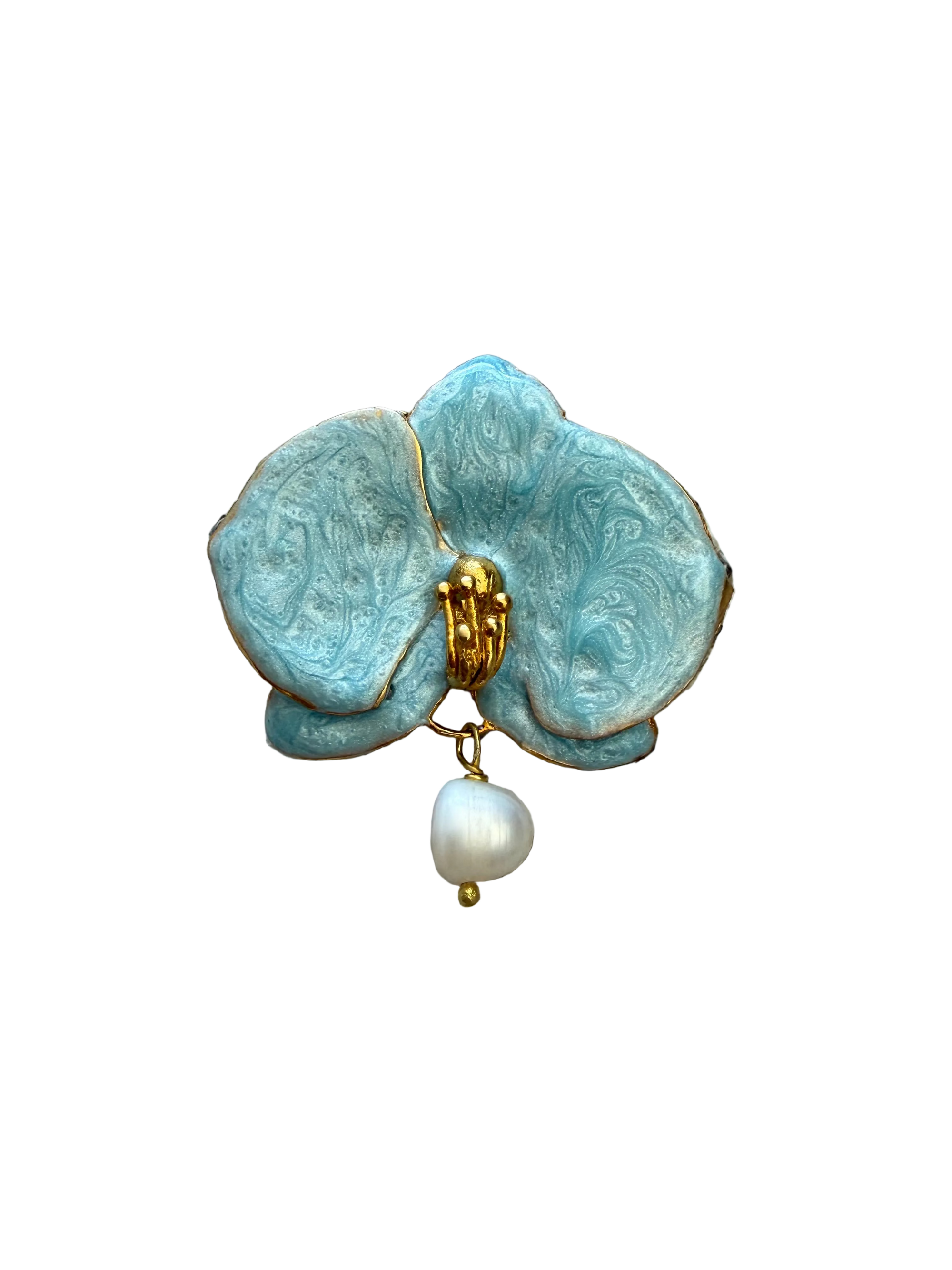 Blue flower-shaped brooch with gold accents and a pearl on a textured beige background