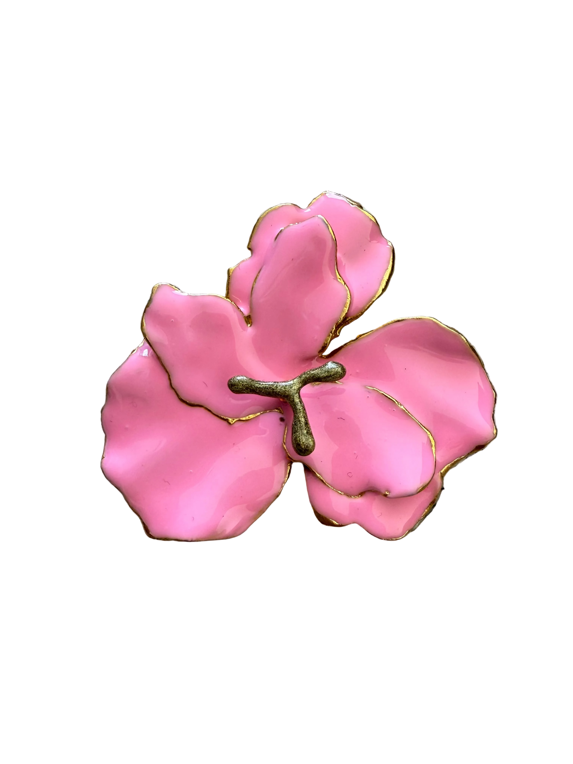 Pink flower-shaped object on a textured beige surface